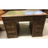 A vintage oak pedestal desk with green leather insert to top.