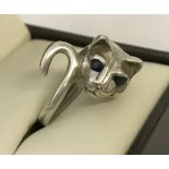 A 925 silver ring in shape of a cat. Set with 2 small sapphires for eyes.