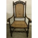 A Victorian carver arm chair with cane seat and back.