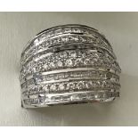 A large 925 silver ladies band style dress ring set with clear stones.