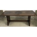 A vintage dark wood refectory style coffee table with trefoil design cut outs to base.