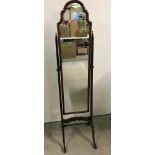 A vintage dark wood framed cheval mirror.