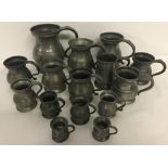 A collection of antique pewter measures and tankards.