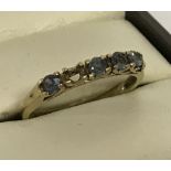 9ct gold dress ring set with 4 blue/green stones.