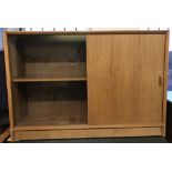 A retro light teak sliding door sideboard with one glazed panel and one wood.