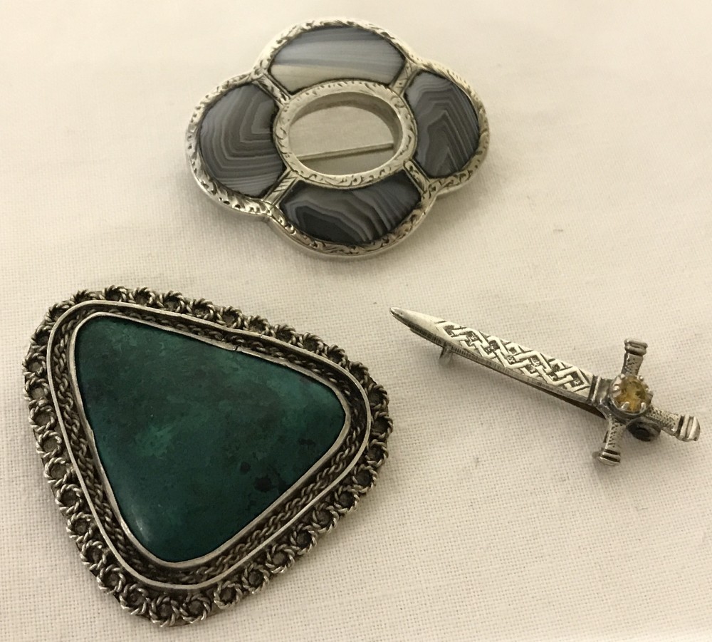 3 stone set vintage silver brooches.