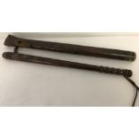 An antique Norfolk Constabulary wooden truncheon with leather strap to grip.