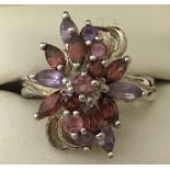 A 925 silver dress ring with unusual floral amethyst, garnet and pink topaz set design.