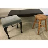 A dark wood rectangular coffee table together with 2 stools.