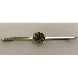 Vintage 9ct gold bar brooch set with a central sapphire surrounded by 8 seed pearls.