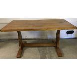 A vintage light wood refectory style dining table.