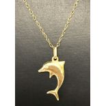 A 9ct gold dolphin pendant on a gold chain.