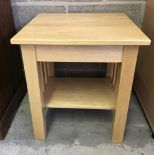 A modern square topped pine side table.