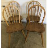 A set of 4 blonde Ercol stick back dining chairs.