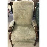 A wooden framed reclining armchair with pale green chenille upholstery with floral design.