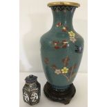 A cloisonné vase with bird and cherry blossom design on a wooden base.