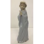 A Nao figurine of a young girl praying.