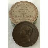 A bronze Price Arthur 1874 Exhibition medallion with circular presentation box.