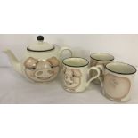 An Arthur Woods pig teapot and matching mugs.