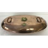 A large antique copper oval bed warmer.