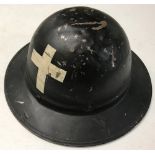 A WWI pattern US army Chaplains tin helmet.