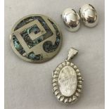 A round paua shell set Mexican silver brooch.