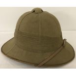 An original circa WW2 period Pith Helmet with liner and chin strap.