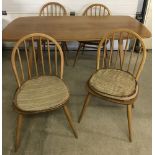 An Ercol blonde mid century plank dining table and 4 matching chairs.