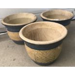 A set of 3 matching garden pots with blue and yellow decoration to sides.