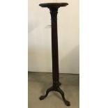 A decorative Victorian mahogany torchiere.