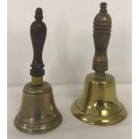 2 brass bells with turned wooden handles.