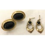 2 pairs of 9ct gold earrings set with black stones.