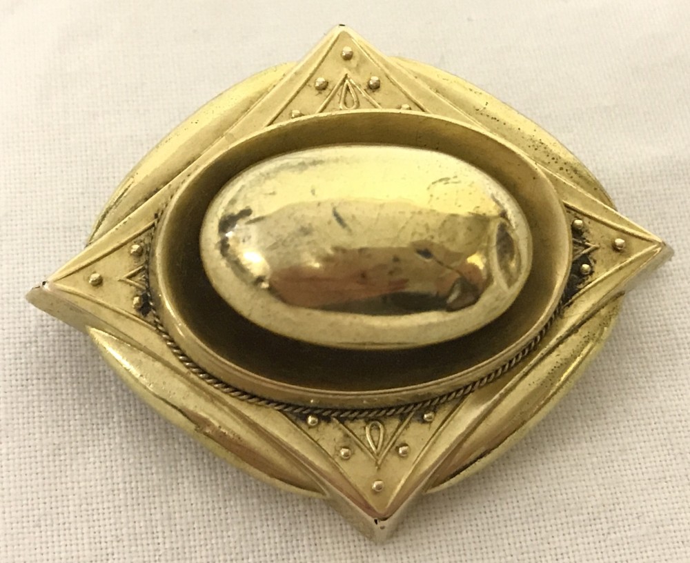 Gold Victorian mourning brooch with compartment at the back for hair or photo.