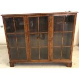 A vintage walnut 3 door glass fronted display cabinet.