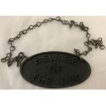 A cast metal "Beware of the Dog" sign.