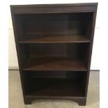 A vintage dark wood 3 shelf bookcase with 2 adjustable shelves.