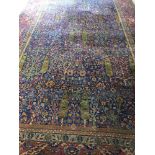 A very large Persian / Indian carpet with blue background.