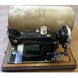 A cased vintage Harris 9H sewing machine.