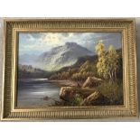 Gilt framed oil on canvas of a landscape with a fisherman in the foreground.