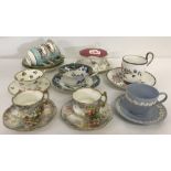 A collection of 9 vintage ceramic cups and saucers.