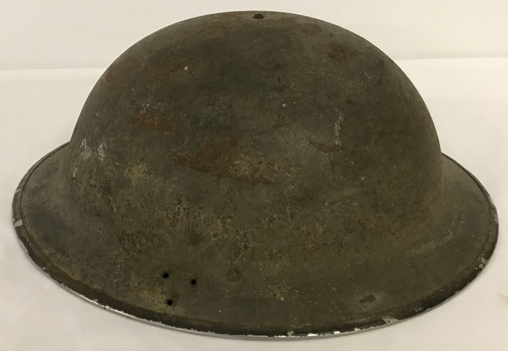 A WW2 pattern British tin helmet with liner.