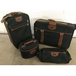 A 4 piece unused Antler luggage set in dark green with brown trim.