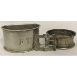 2 hallmarked silver monogrammed napkin rings together with a small silver buckle.