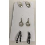 3 pairs of silver earrings.