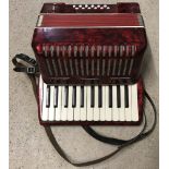 A vintage German red and black pearlised design accordion.