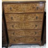 A vintage walnut veneer 5 draw chest on small cabriole style legs.