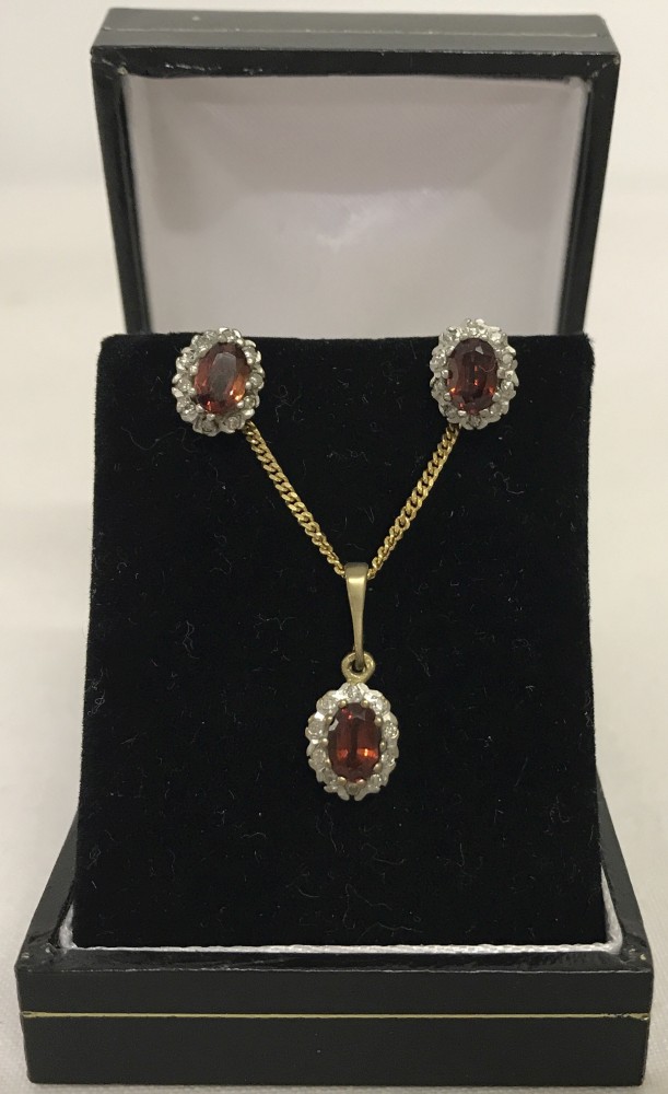 9ct gold garnet and diamond set necklace and matching earrings.