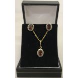9ct gold garnet and diamond set necklace and matching earrings.