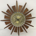 A c1970's retro sunburst wall clock. In working order.