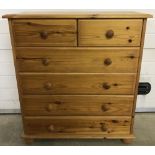 A modern pine 2 over 4 chest of drawers with bun feet.